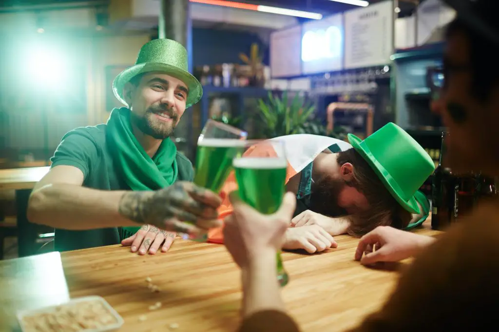 people drinking green beers