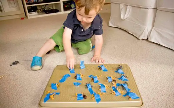 kid playing animal tape rescue activity