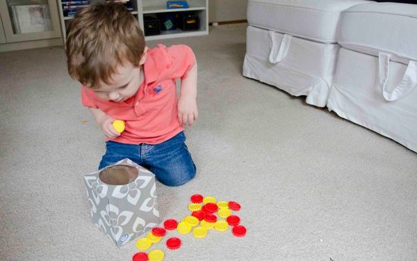 kid playing drop box taby activity